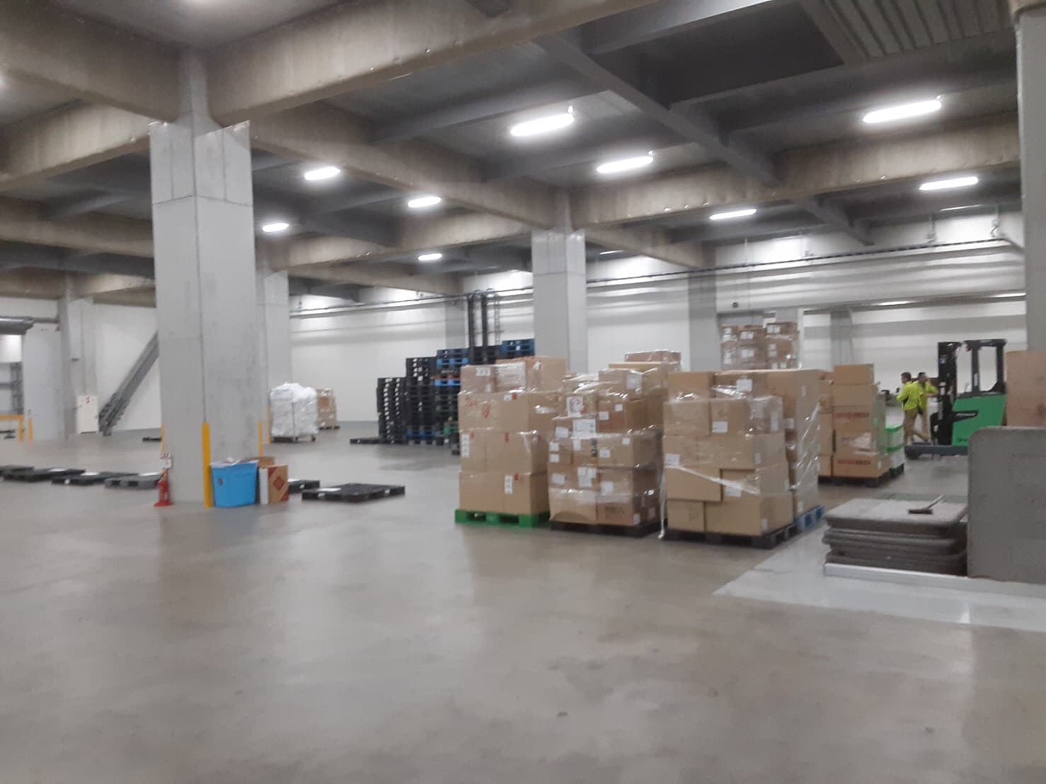 Warehouse interior with pallets and a forklift